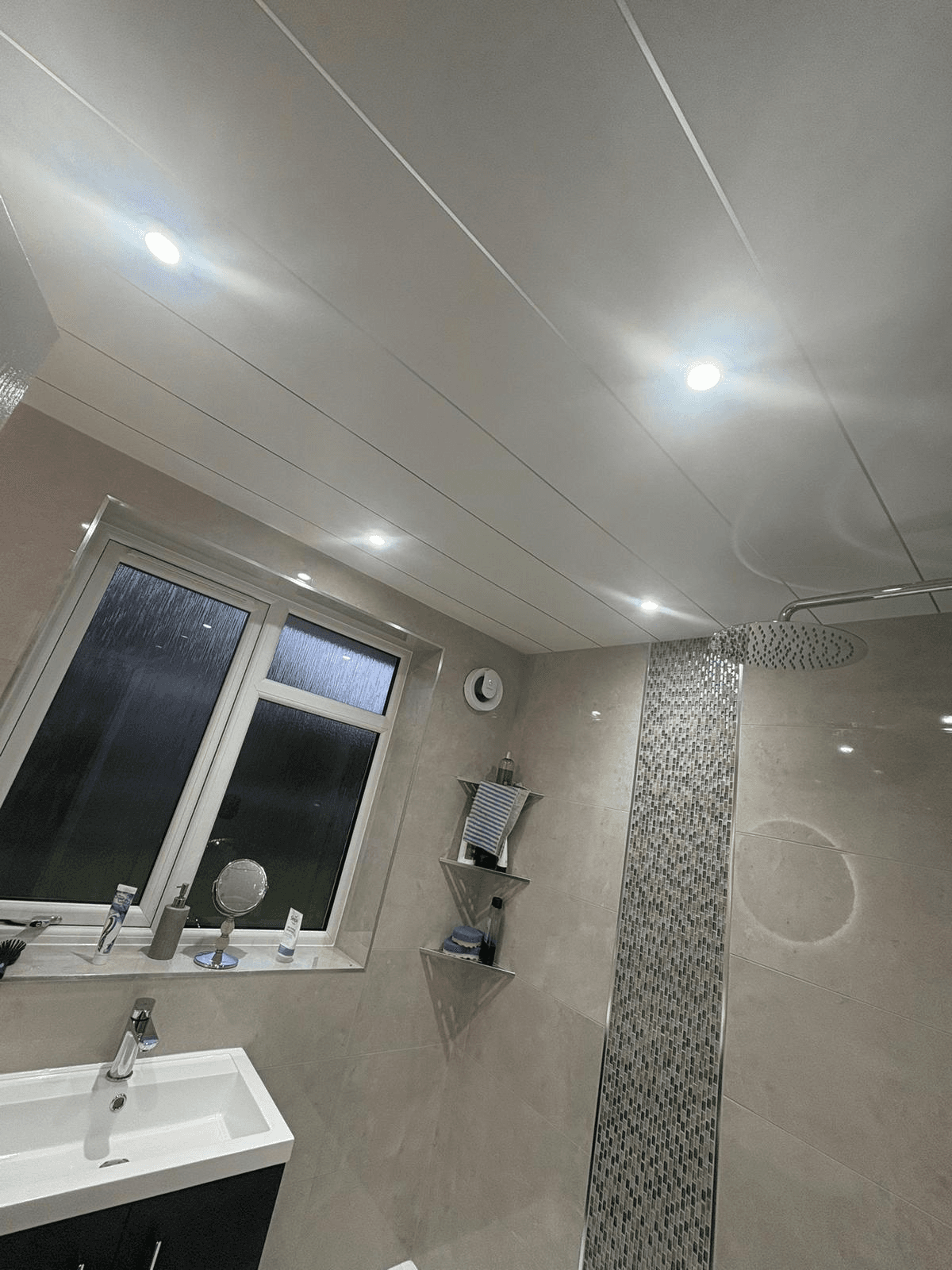Bathroom with recessed LED downlights and shower area