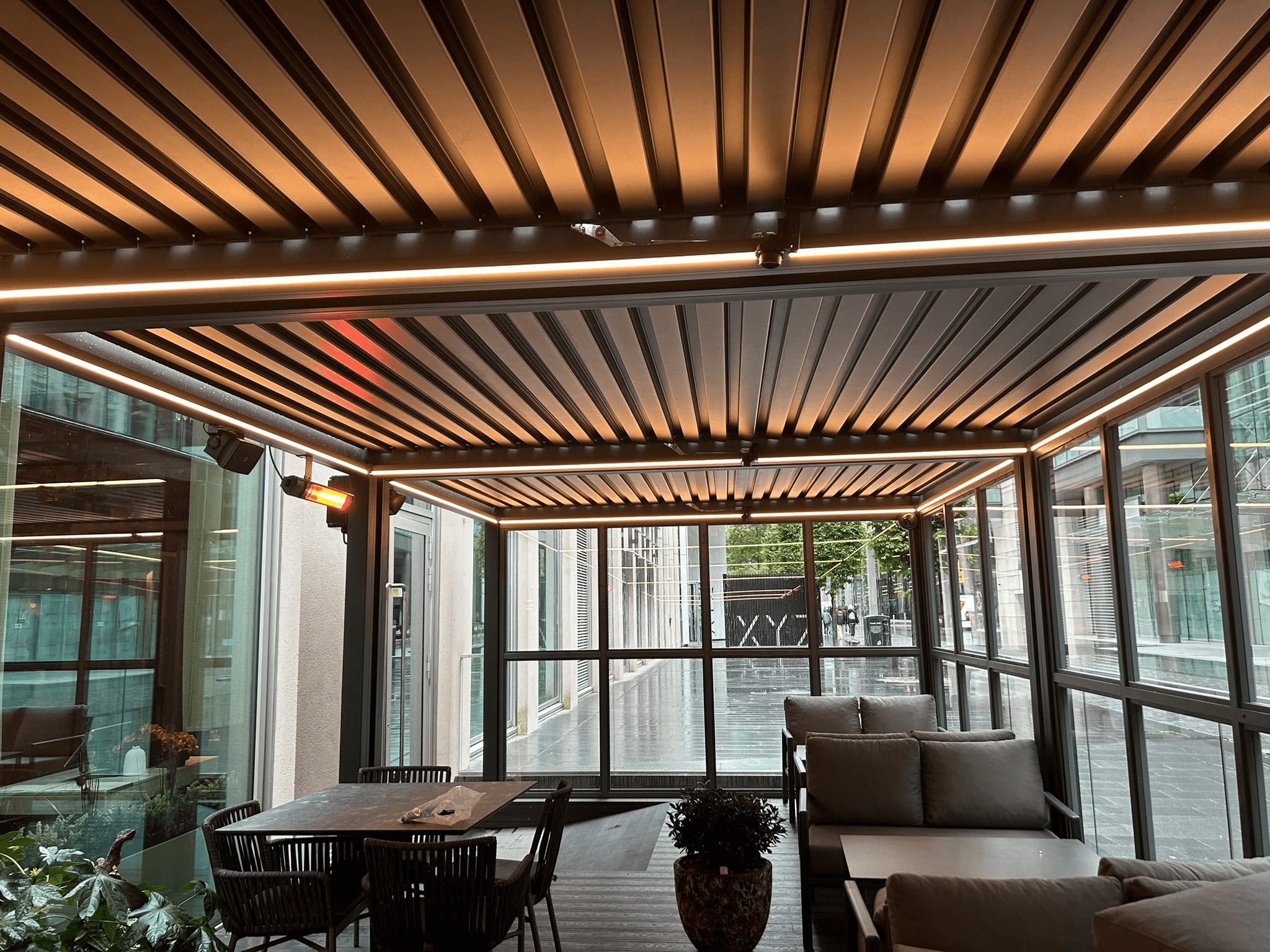 Commercial outdoor dining area with LED strip lighting fitted to pergola ceiling beams