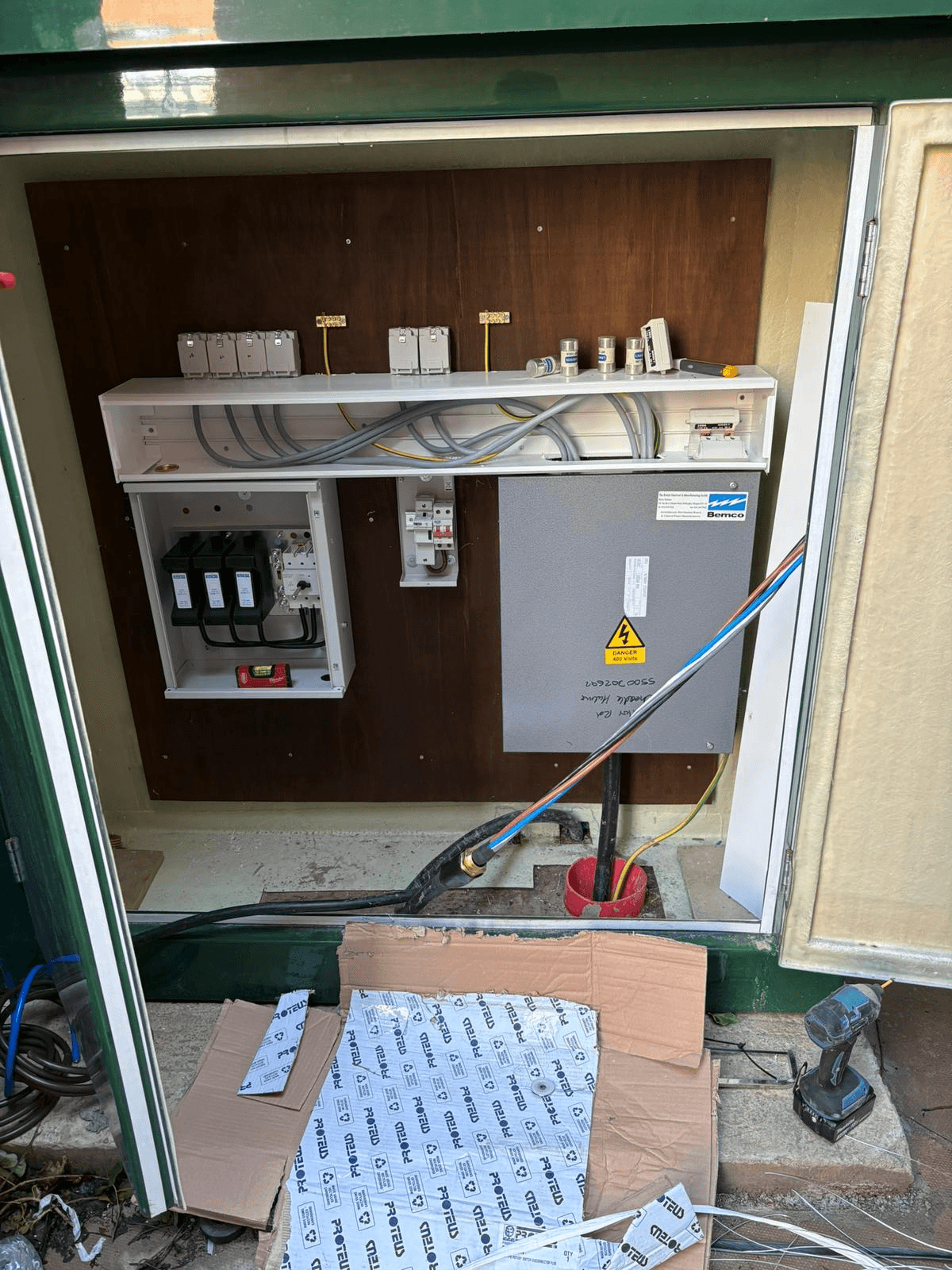 Consumer unit and wiring installation inside a green outdoor electrical cabinet