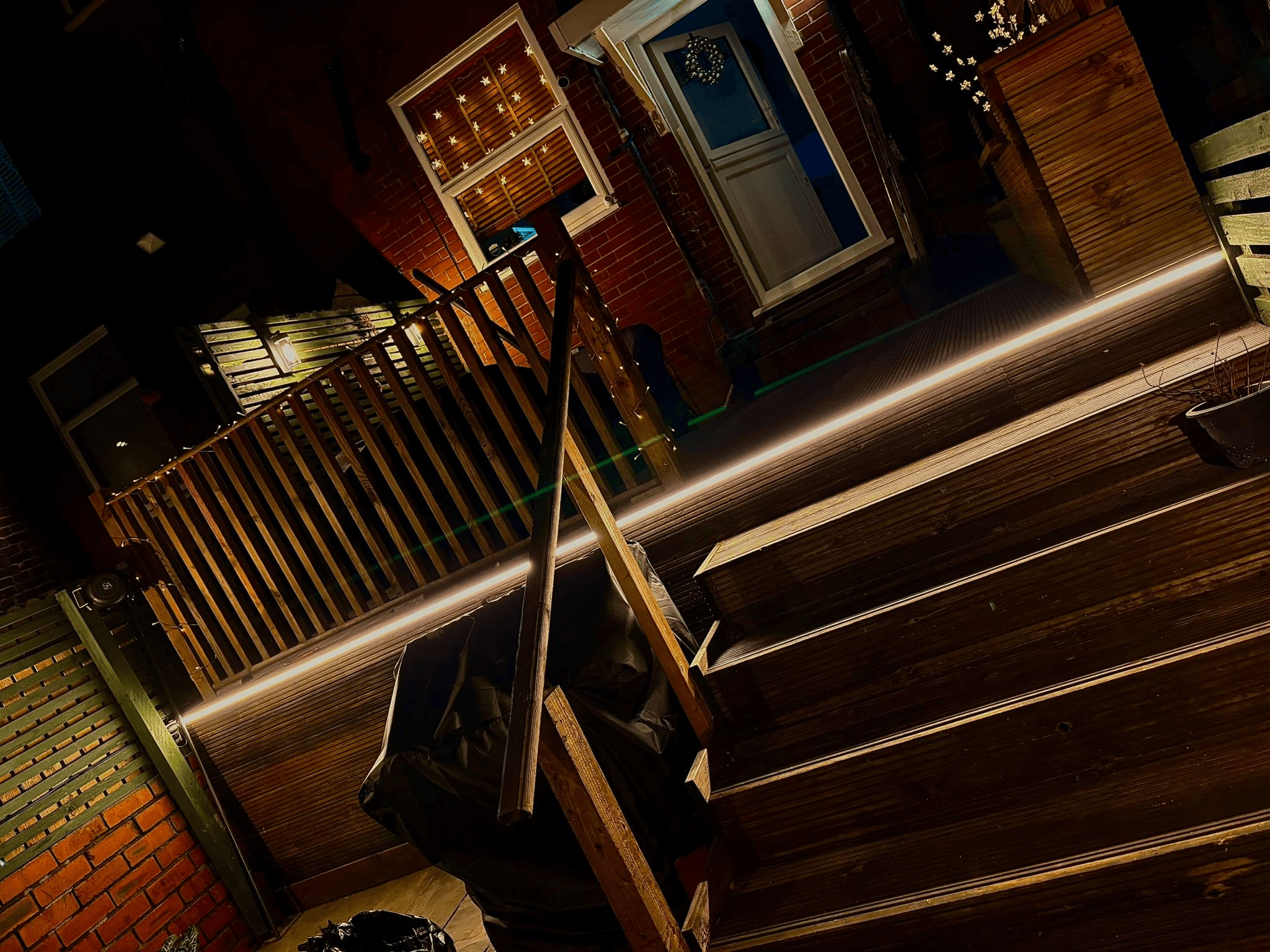 LED strip lighting fitted under wooden deck steps at night