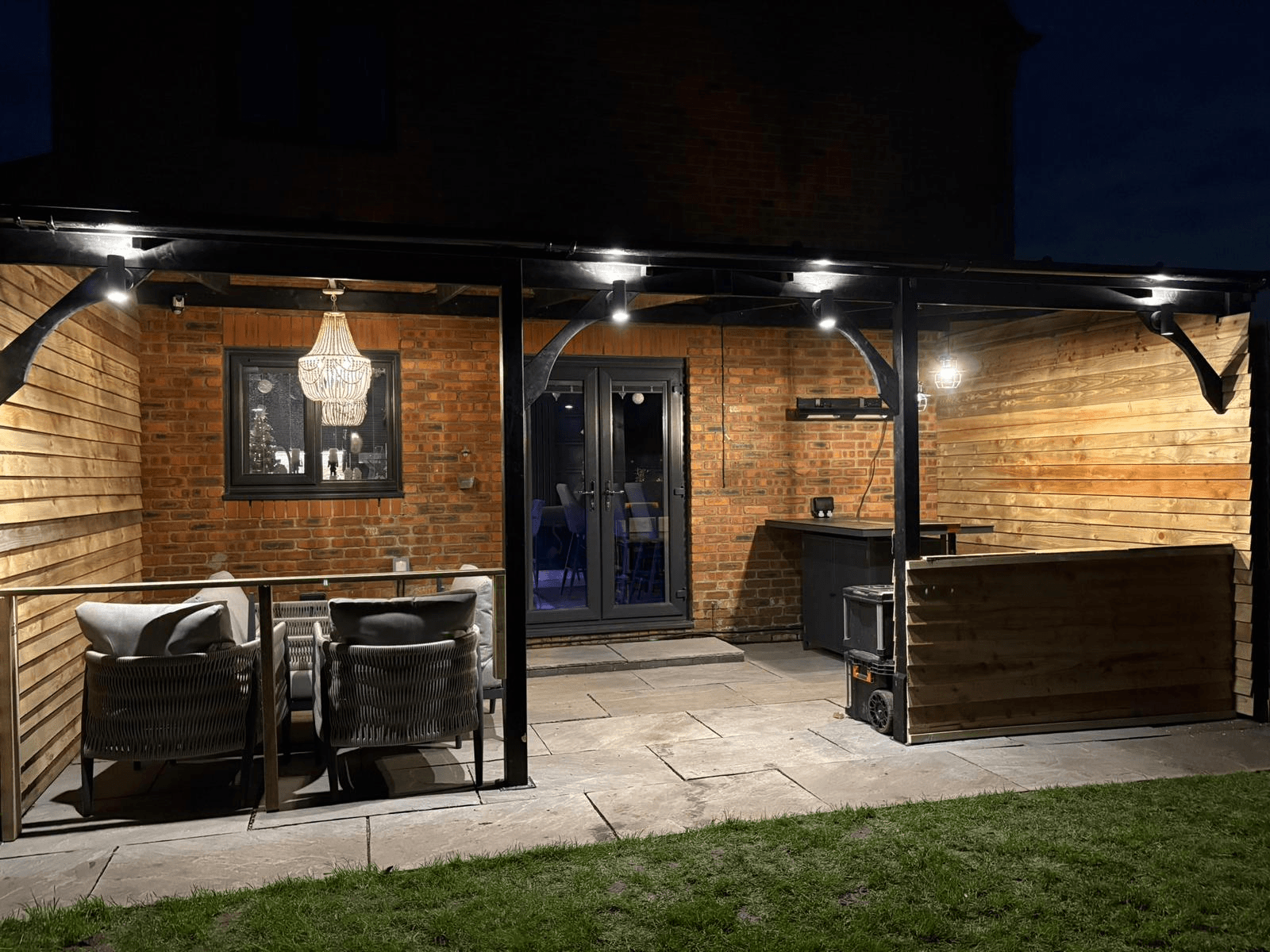 Garden room and outdoor bar with full lighting installation at night