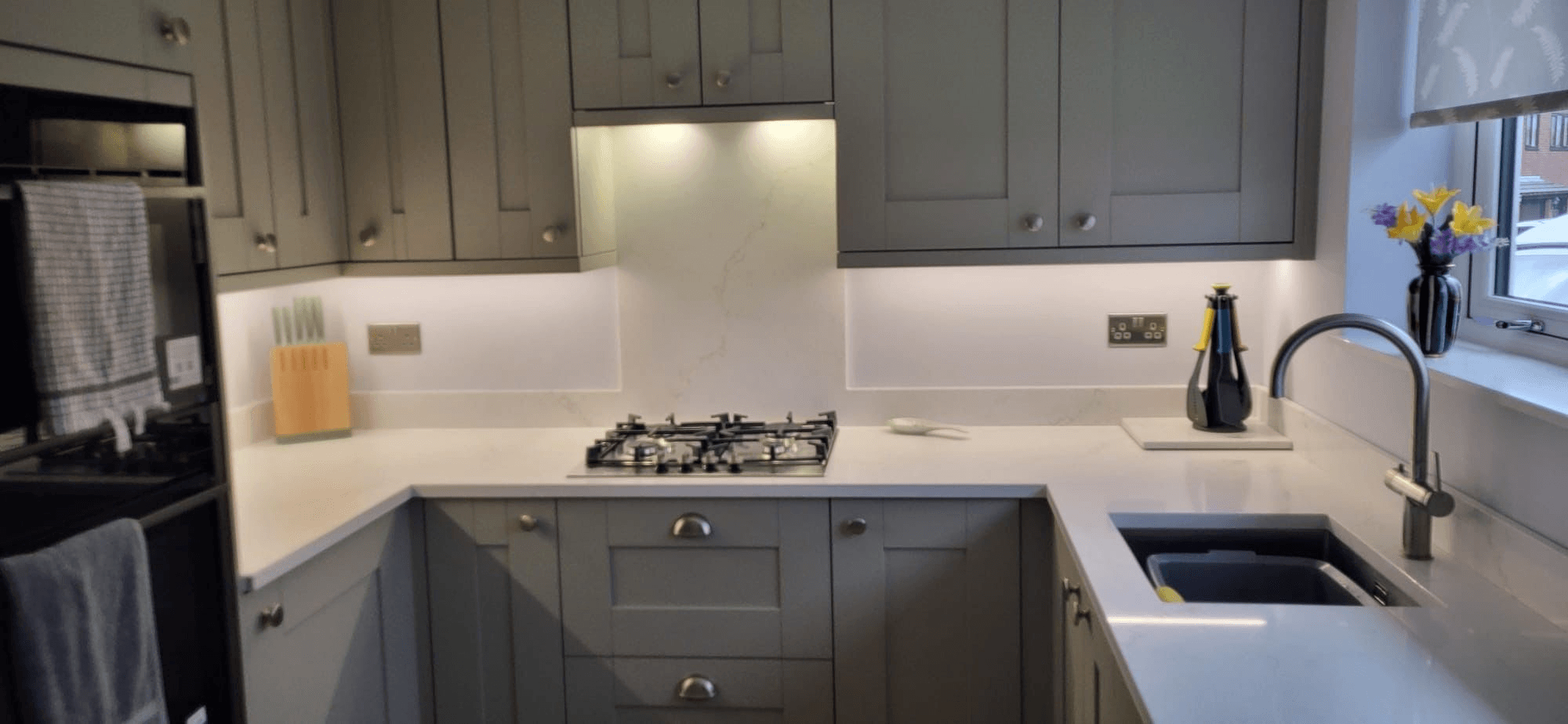 Under-cabinet LED strip lights in fitted kitchen