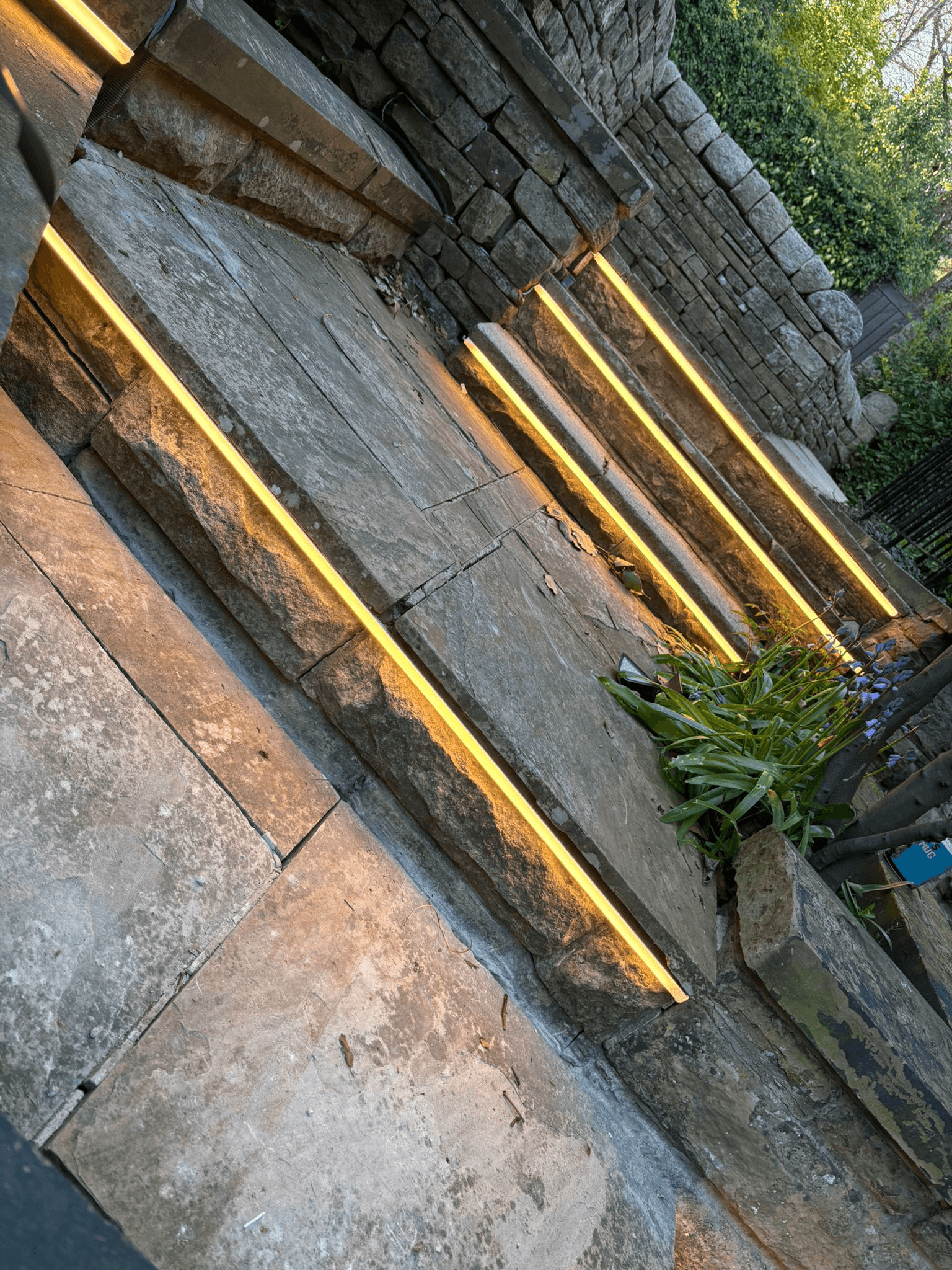 LED strip lighting fitted under stone garden steps